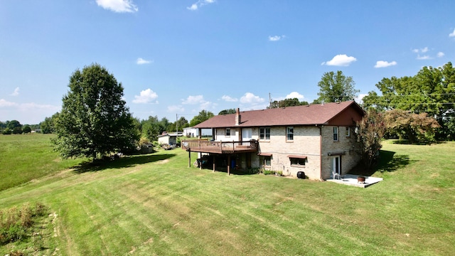 back of house with a lawn and a wooden deck