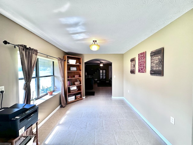 office area with a textured ceiling and ceiling fan