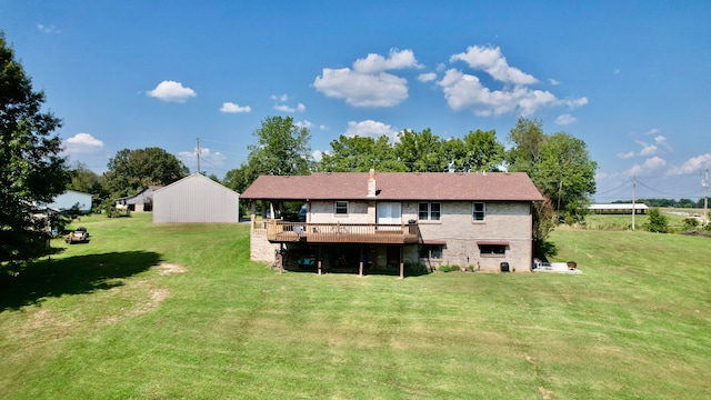 rear view of property featuring a yard, a wooden deck, and a shed