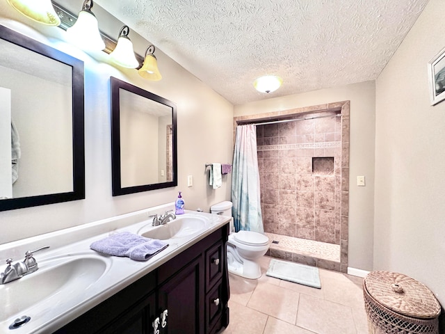 bathroom with toilet, walk in shower, tile patterned flooring, vanity, and a textured ceiling