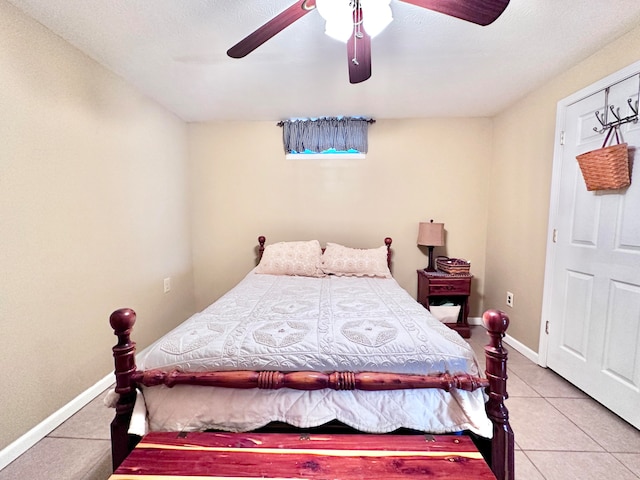 tiled bedroom featuring ceiling fan