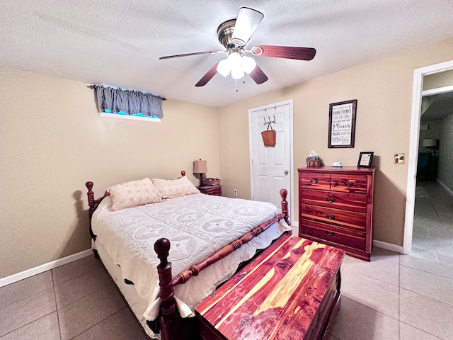 tiled bedroom featuring ceiling fan and a textured ceiling