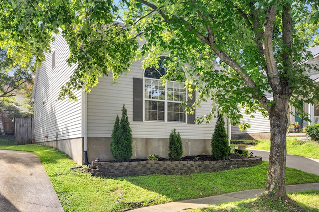 view of side of home with a lawn