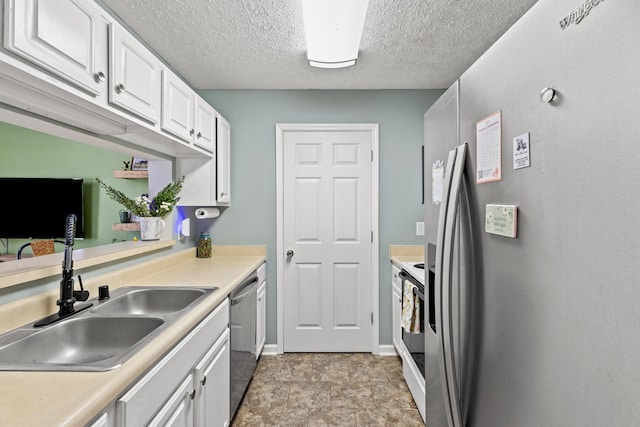 kitchen featuring sink, appliances with stainless steel finishes, a textured ceiling, light tile patterned floors, and white cabinets