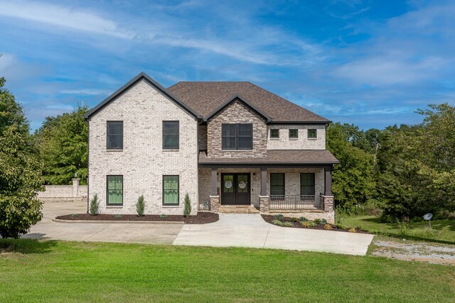 view of front of house with a front yard and a porch