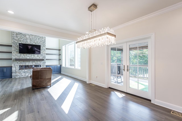 unfurnished living room with ornamental molding, visible vents, a fireplace, and dark wood-style floors