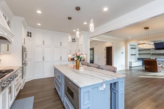 kitchen featuring hanging light fixtures, white cabinetry, glass insert cabinets, and a center island