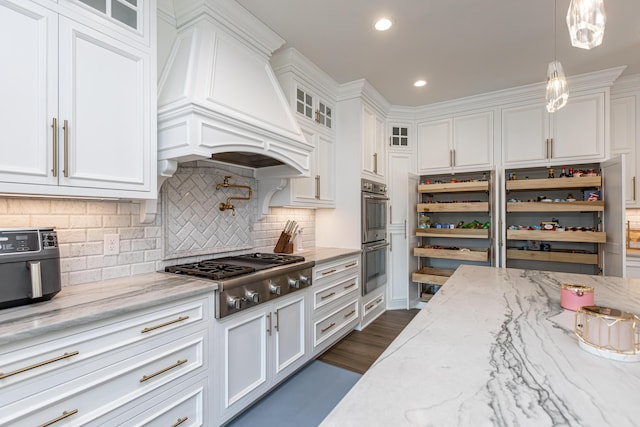 kitchen with glass insert cabinets, white cabinets, and appliances with stainless steel finishes