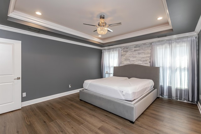 bedroom featuring a raised ceiling, visible vents, dark wood finished floors, and baseboards