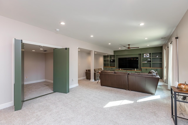 living room with ceiling fan, light carpet, baseboards, and recessed lighting