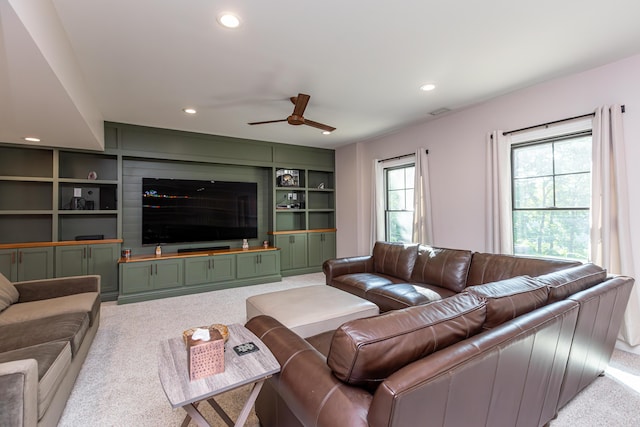 living room featuring built in shelves, recessed lighting, light carpet, and visible vents