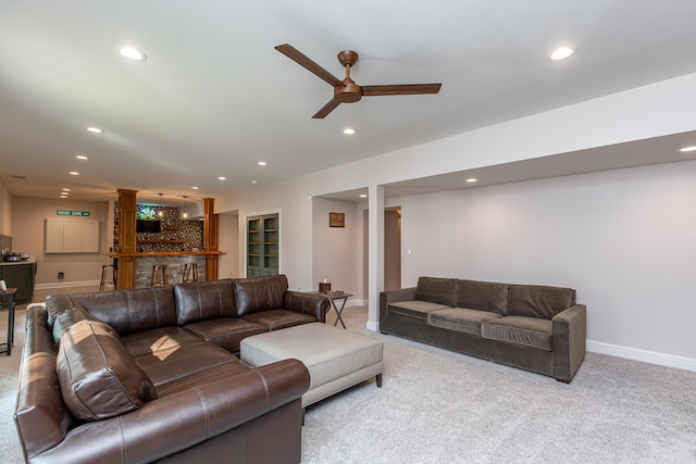 living area featuring recessed lighting, indoor bar, and light colored carpet