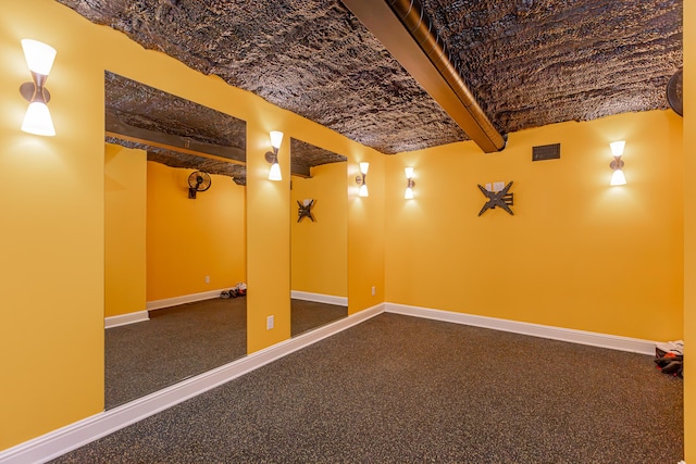 finished basement featuring baseboards and visible vents