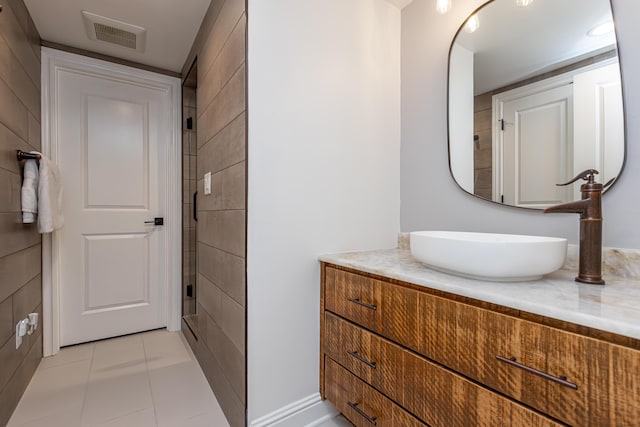 bathroom with tile patterned flooring, vanity, and visible vents