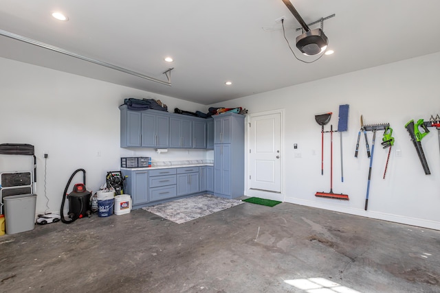 garage with recessed lighting and a garage door opener