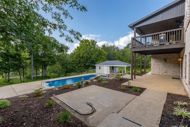 pool with a patio area, an outdoor structure, and a storage structure