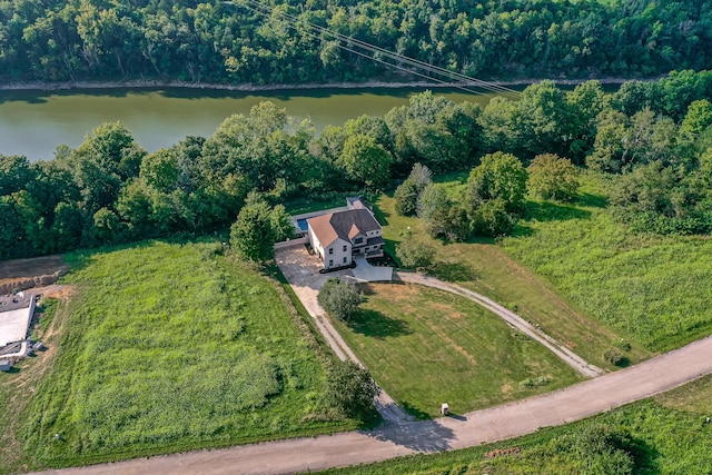 drone / aerial view featuring a water view and a view of trees