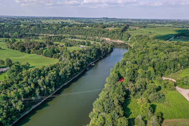 drone / aerial view with a water view and a forest view