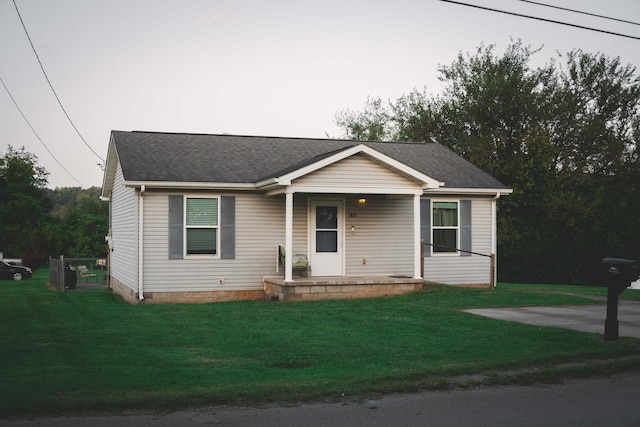 view of front facade with a front yard and covered porch