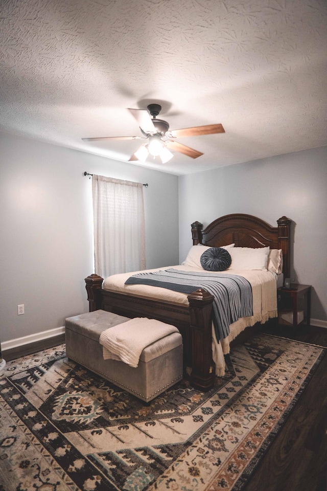 bedroom with a textured ceiling and ceiling fan