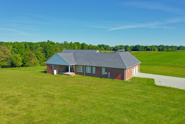 rear view of property with a lawn