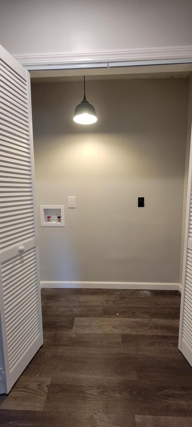 washroom featuring hookup for a washing machine, laundry area, dark wood-type flooring, and baseboards