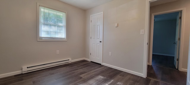 unfurnished bedroom with dark wood-type flooring and a baseboard radiator