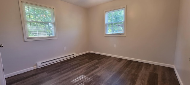 unfurnished room with a baseboard heating unit, a wealth of natural light, baseboards, and dark wood-style floors