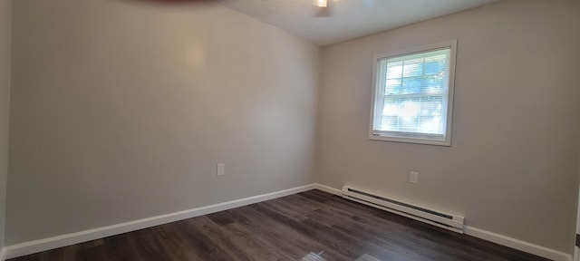 unfurnished room featuring dark wood-type flooring, a baseboard radiator, and baseboards