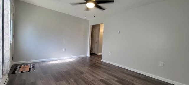 empty room with dark wood-type flooring, baseboards, and a ceiling fan