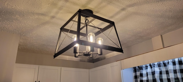 room details with a chandelier and a textured ceiling