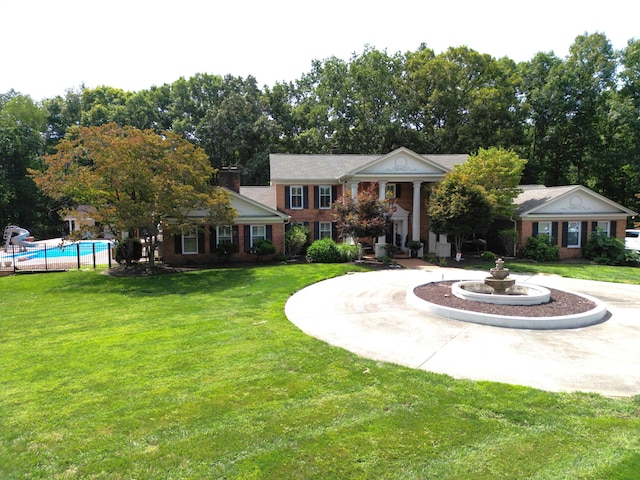 greek revival house featuring a front lawn