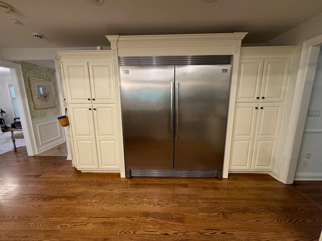 kitchen with white cabinets, dark hardwood / wood-style floors, and built in refrigerator