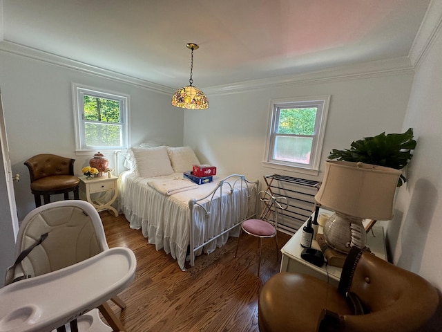 bedroom with multiple windows, crown molding, and wood-type flooring