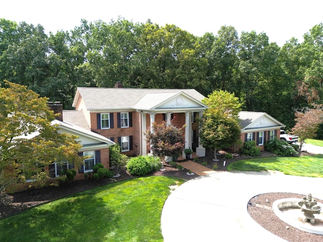 neoclassical / greek revival house with a front lawn