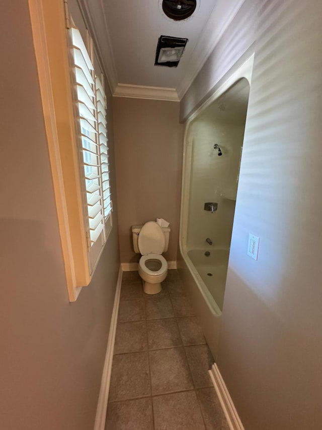 bathroom featuring tile patterned flooring, toilet, and crown molding