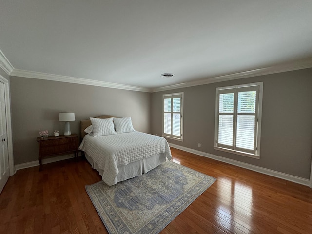 bedroom with hardwood / wood-style flooring and crown molding