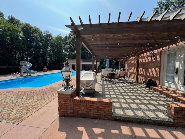 view of pool with a patio, a water slide, outdoor lounge area, and a pergola