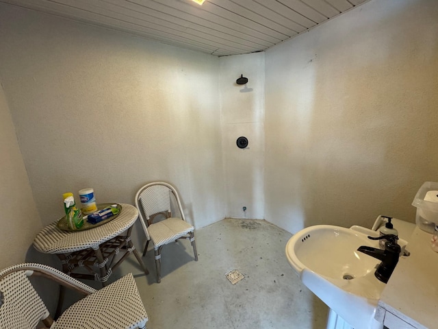 bathroom featuring sink and concrete flooring