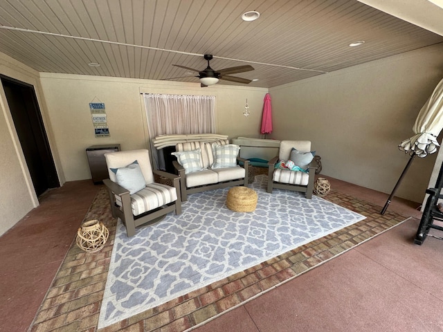 living room featuring ceiling fan and wood ceiling