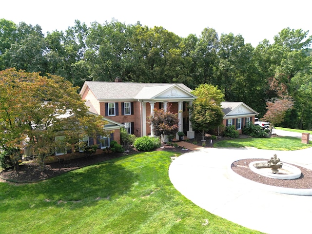 greek revival house featuring a front lawn