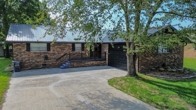 single story home with a garage and a front lawn