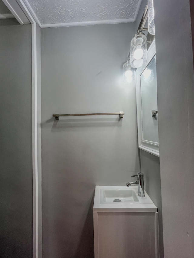 bathroom featuring a textured ceiling and vanity