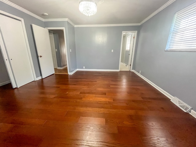 interior space featuring ornamental molding, dark hardwood / wood-style flooring, and a notable chandelier