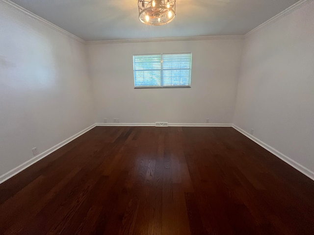 empty room with crown molding and dark hardwood / wood-style flooring