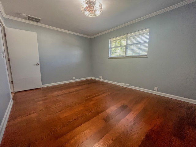 spare room featuring ornamental molding and hardwood / wood-style flooring