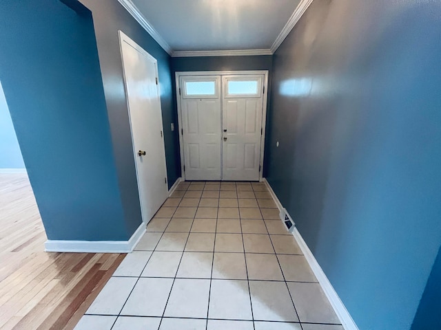 doorway featuring ornamental molding and light hardwood / wood-style floors