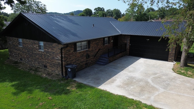 single story home featuring a garage and a front yard