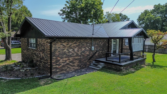 exterior space with a yard and a wooden deck