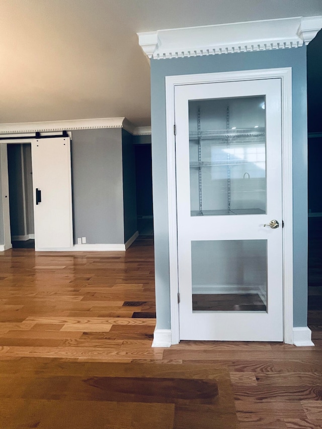 interior space featuring hardwood / wood-style flooring and a barn door